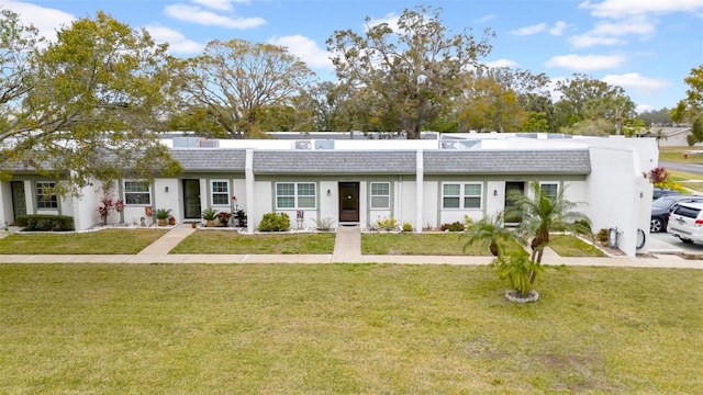 ranch-style home with a front lawn