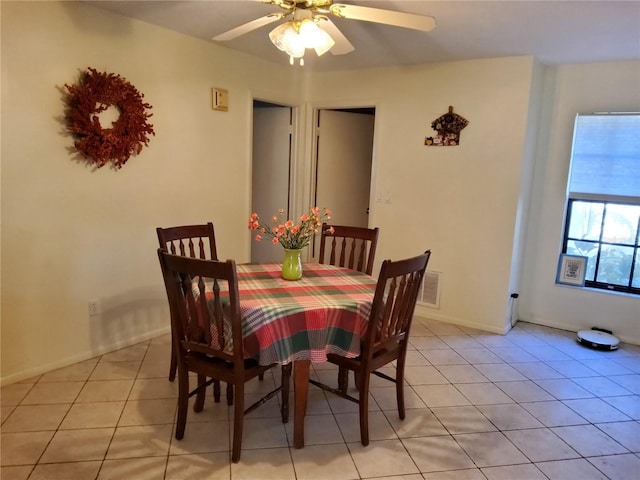 tiled dining area featuring ceiling fan