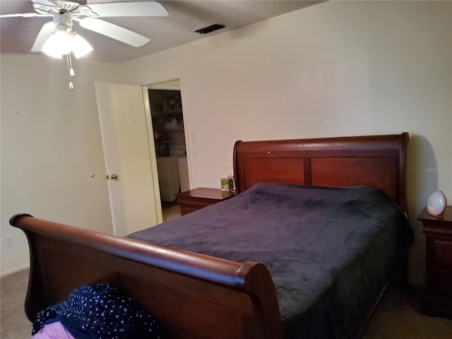 bedroom with separate washer and dryer, carpet floors, and ceiling fan