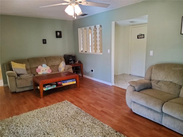 living room featuring hardwood / wood-style flooring and ceiling fan