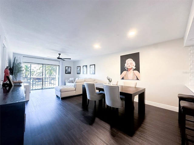 dining room featuring baseboards, dark wood finished floors, and a ceiling fan