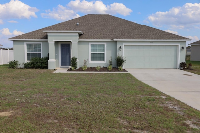 ranch-style house featuring a garage and a front yard