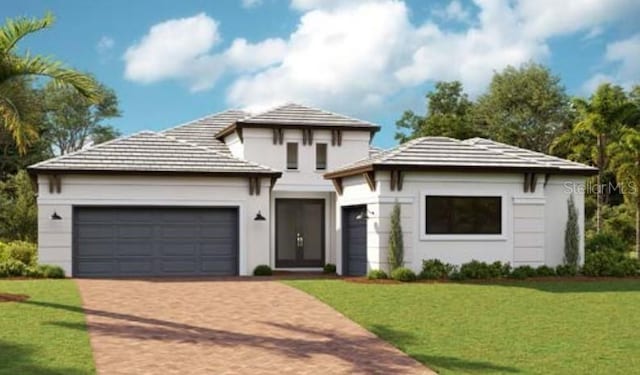 view of front of house with a garage and a front lawn