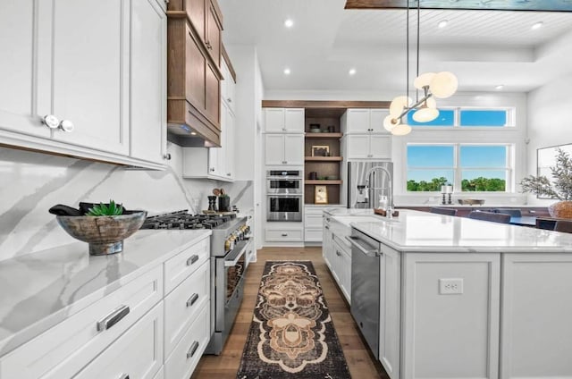 kitchen featuring pendant lighting, sink, white cabinetry, a kitchen island with sink, and stainless steel appliances