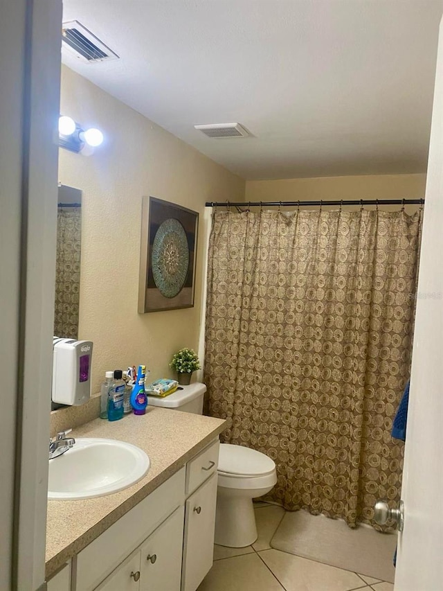 bathroom featuring vanity, toilet, and tile patterned flooring