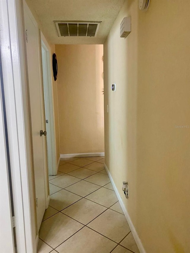 hallway with light tile patterned floors