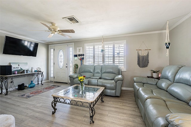 living room featuring crown molding, ceiling fan, and light wood-type flooring