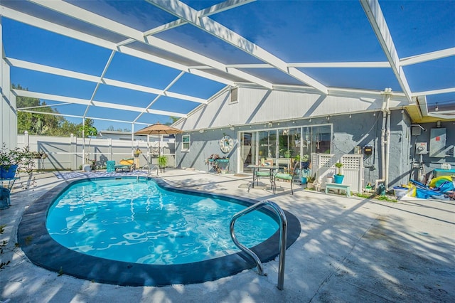 view of swimming pool with a lanai and a patio area