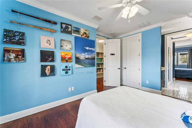 bedroom with crown molding, ceiling fan, and dark hardwood / wood-style flooring