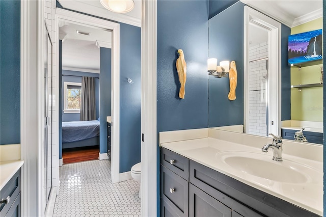 bathroom with vanity, ornamental molding, tile patterned floors, and toilet