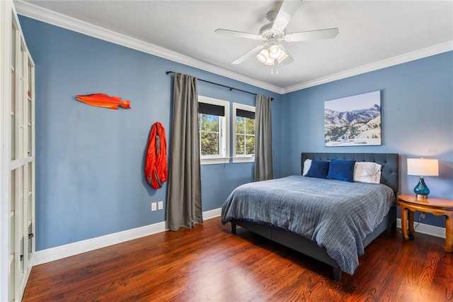 bedroom featuring a ceiling fan, crown molding, baseboards, and wood finished floors