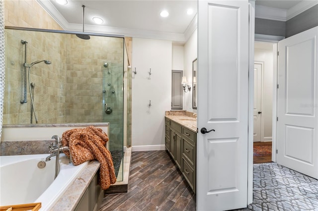 bathroom featuring hardwood / wood-style flooring, plus walk in shower, ornamental molding, and vanity