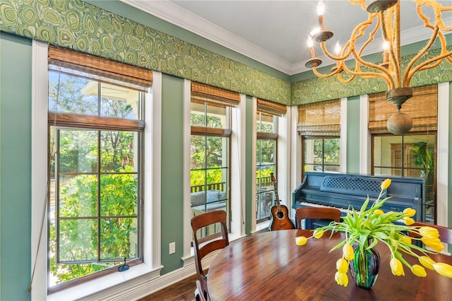 sunroom / solarium featuring a wealth of natural light and a chandelier