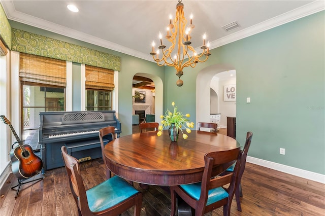 dining room with an inviting chandelier, crown molding, and dark wood-type flooring