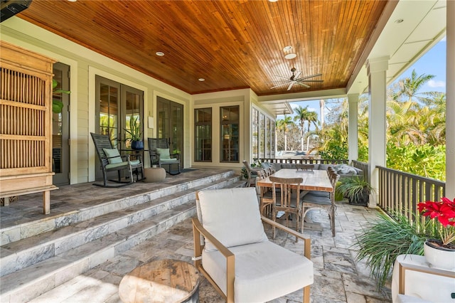 view of patio featuring outdoor dining area and a ceiling fan