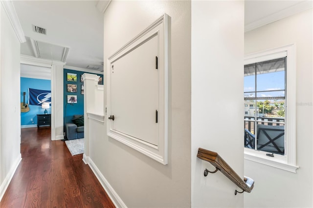 hallway featuring ornamental molding and dark hardwood / wood-style flooring