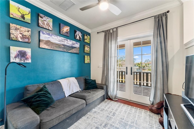 living room featuring wood finished floors, visible vents, a ceiling fan, french doors, and crown molding