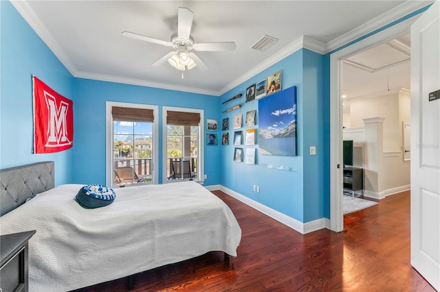 bedroom with attic access, visible vents, ornamental molding, and wood finished floors