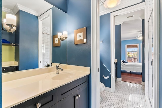 bathroom featuring tile patterned flooring, vanity, ceiling fan, toilet, and crown molding