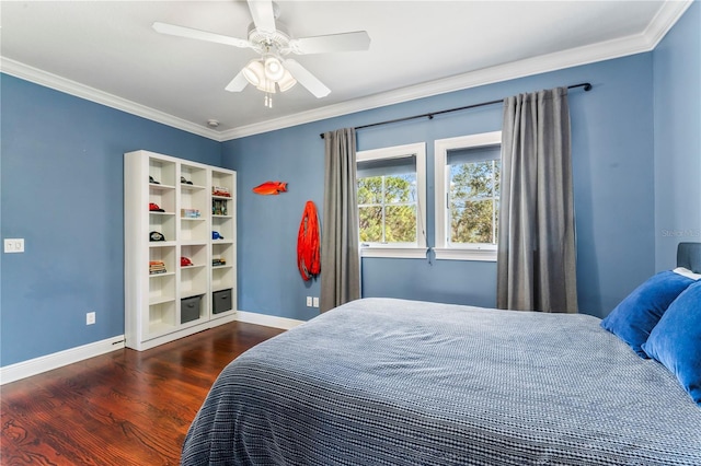 bedroom with baseboards, ceiling fan, wood finished floors, and crown molding