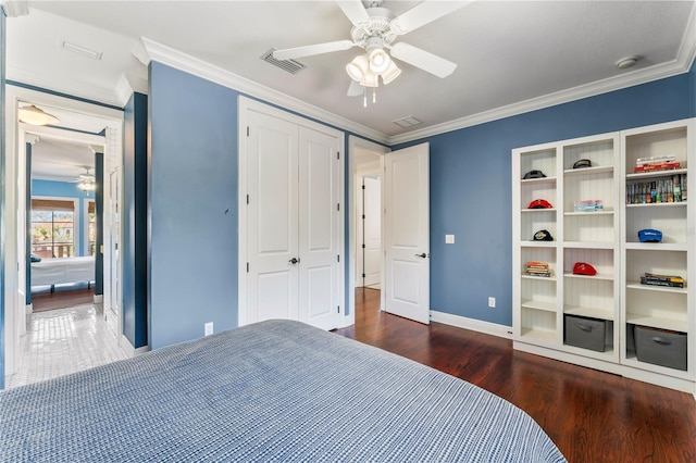 bedroom featuring visible vents, wood finished floors, and ornamental molding