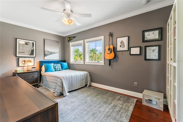 bedroom featuring ornamental molding, wood finished floors, a ceiling fan, and baseboards