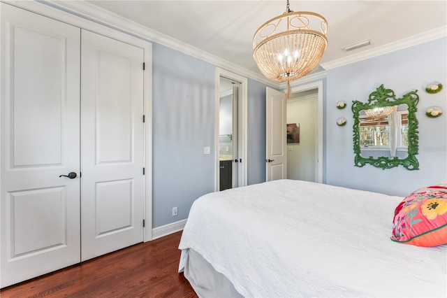 bedroom with ornamental molding, dark wood-type flooring, and a notable chandelier