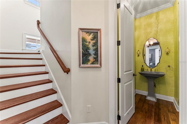 staircase featuring wallpapered walls, baseboards, and wood finished floors