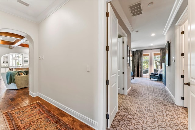 corridor with hardwood / wood-style flooring, ornamental molding, beam ceiling, and coffered ceiling