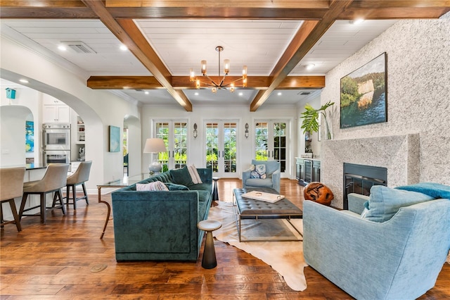 living room with dark hardwood / wood-style floors, a notable chandelier, and beam ceiling