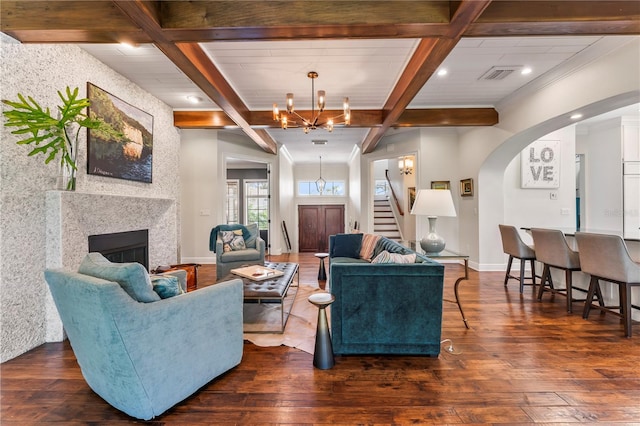 living room featuring an inviting chandelier, beam ceiling, and dark wood-type flooring