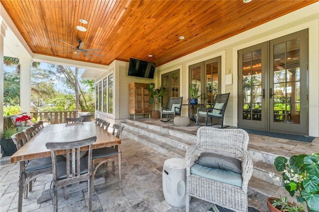 view of patio / terrace featuring outdoor dining space, ceiling fan, and french doors