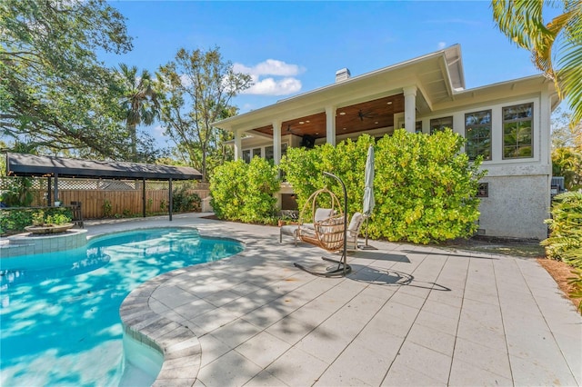 view of pool featuring ceiling fan, a patio area, a fenced backyard, and a fenced in pool