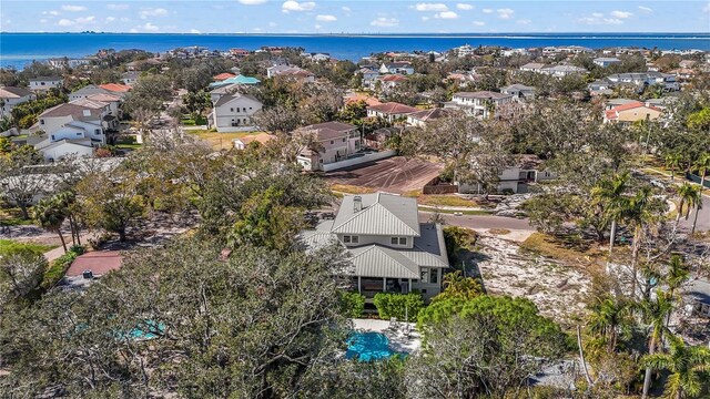 drone / aerial view featuring a residential view and a water view