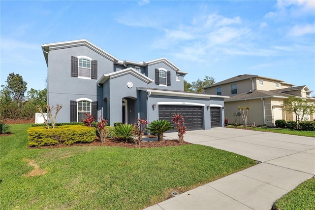 traditional home with a front lawn, concrete driveway, and stucco siding