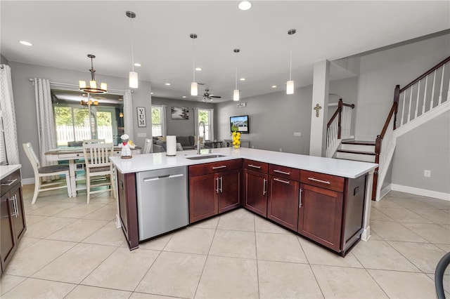 kitchen with light countertops, stainless steel dishwasher, plenty of natural light, and a sink