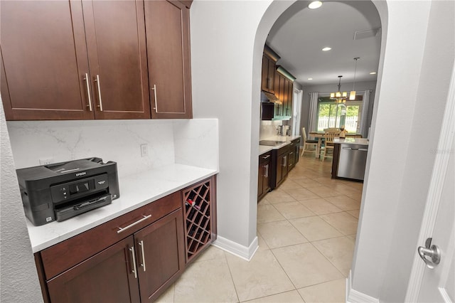 kitchen featuring visible vents, arched walkways, black electric cooktop, stainless steel dishwasher, and backsplash