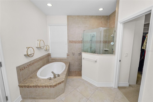 bathroom with a garden tub, recessed lighting, a spacious closet, a walk in shower, and tile patterned flooring