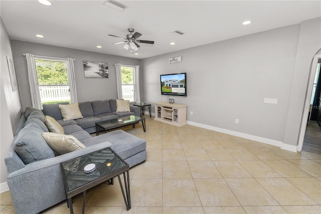 living room featuring light tile patterned flooring, visible vents, and recessed lighting