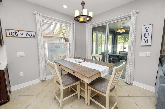 dining space with light tile patterned floors, a wealth of natural light, and baseboards