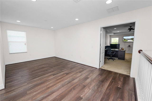 unfurnished room featuring baseboards, visible vents, wood finished floors, and recessed lighting