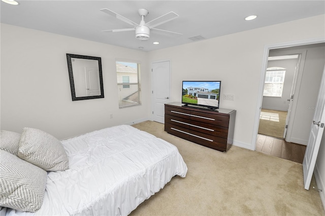 bedroom featuring recessed lighting, visible vents, a ceiling fan, light carpet, and baseboards