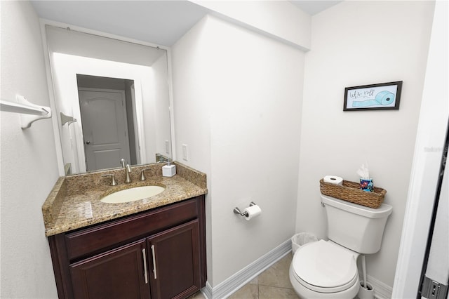 bathroom with tile patterned flooring, vanity, toilet, and baseboards