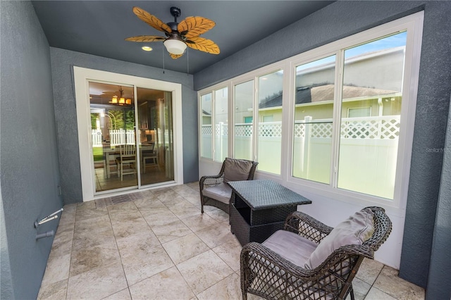 sunroom featuring a ceiling fan