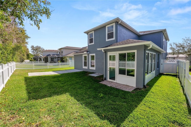 back of house featuring a patio area, a fenced backyard, a yard, and stucco siding