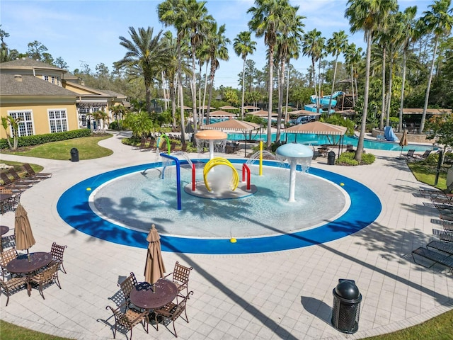 view of swimming pool with a water slide and a water play area