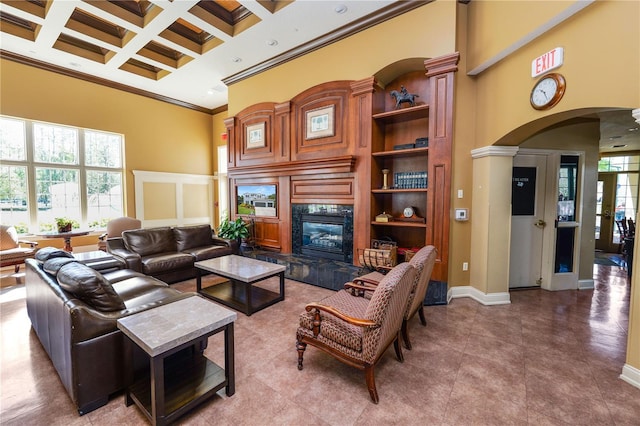 living area featuring arched walkways, coffered ceiling, a towering ceiling, ornamental molding, and beamed ceiling