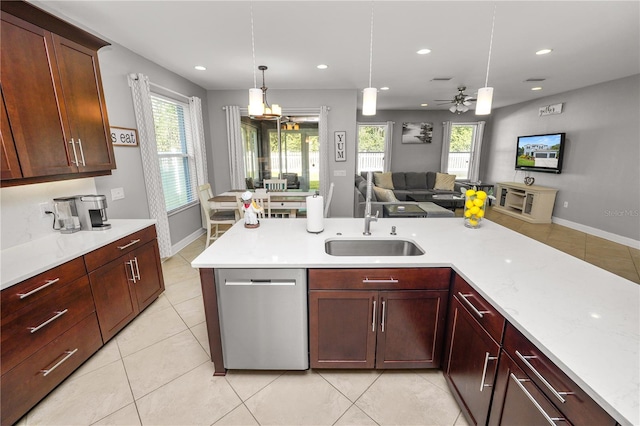 kitchen featuring a sink, light countertops, stainless steel dishwasher, and open floor plan