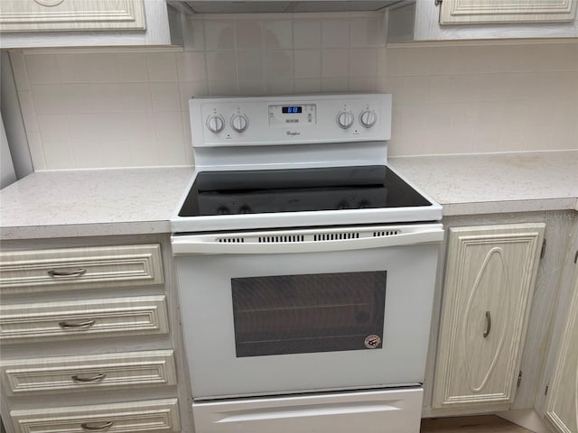 11200 102nd Ave Unit 125, Seminole, FL 33778 - kitchen with decorative backsplash, light countertops, and white electric stove