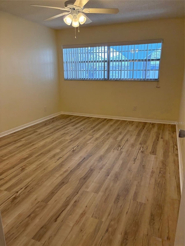 11200 102nd Ave Unit 125, Seminole, FL 33778 - empty room featuring baseboards, a ceiling fan, and wood finished floors